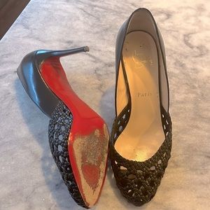 Christian Louboutin heels. Red soles worn and a scratch on one heel.